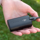 The external battery pack that powers the DJI Goggles 2 being held in hand.
